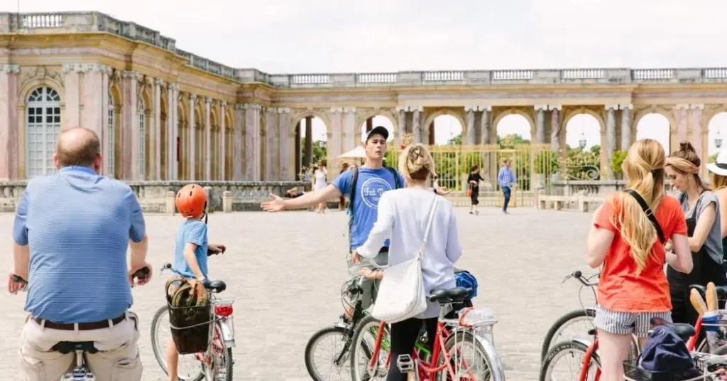 Guide explaining Grand Trianon in the bike tour
