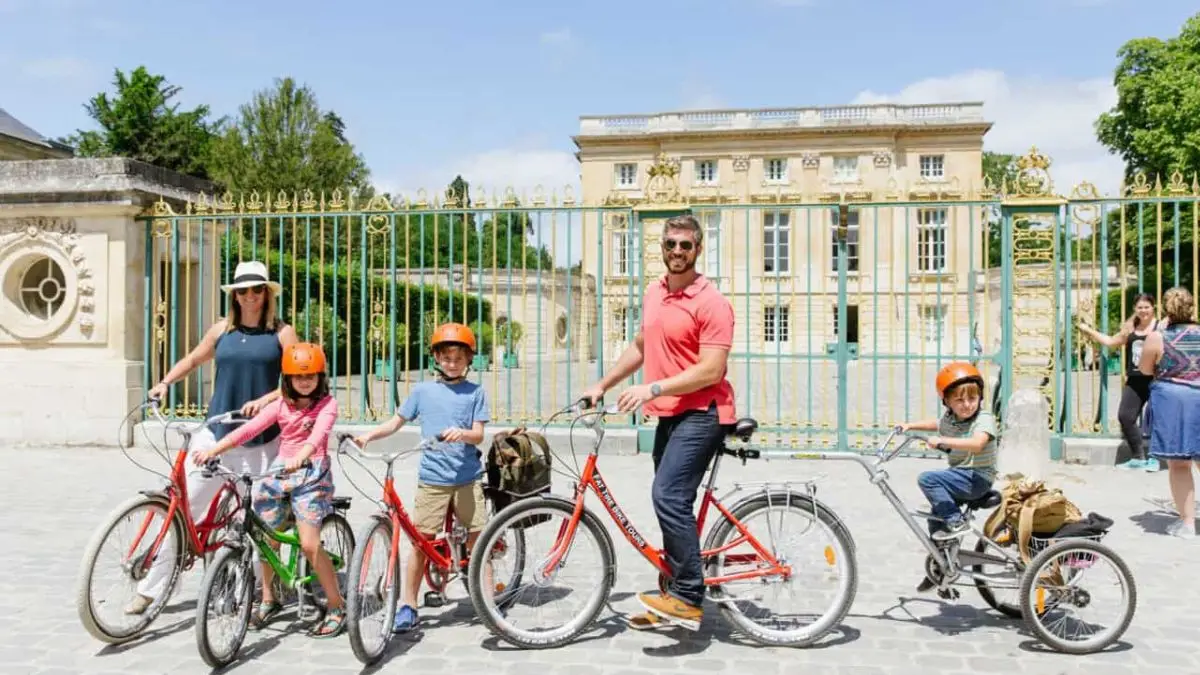 Versailles Bike Tour Tourists with kids enjoying the Versailles Bike Tour in front of Petit Trianon.
